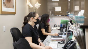 Thewomenschoice Workers Looking at Screens at Reception
