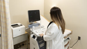 A Doctor Looking at Ultrasound Machine at Thewomenschoice
