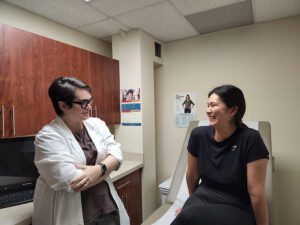 Ericka Quezada York, CNM talking to the patient