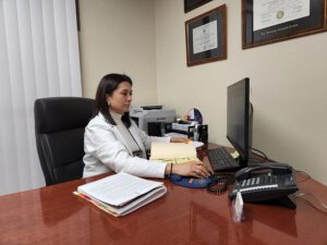 Nargiza Gapparova MSN, AGPCNP working with patient charts